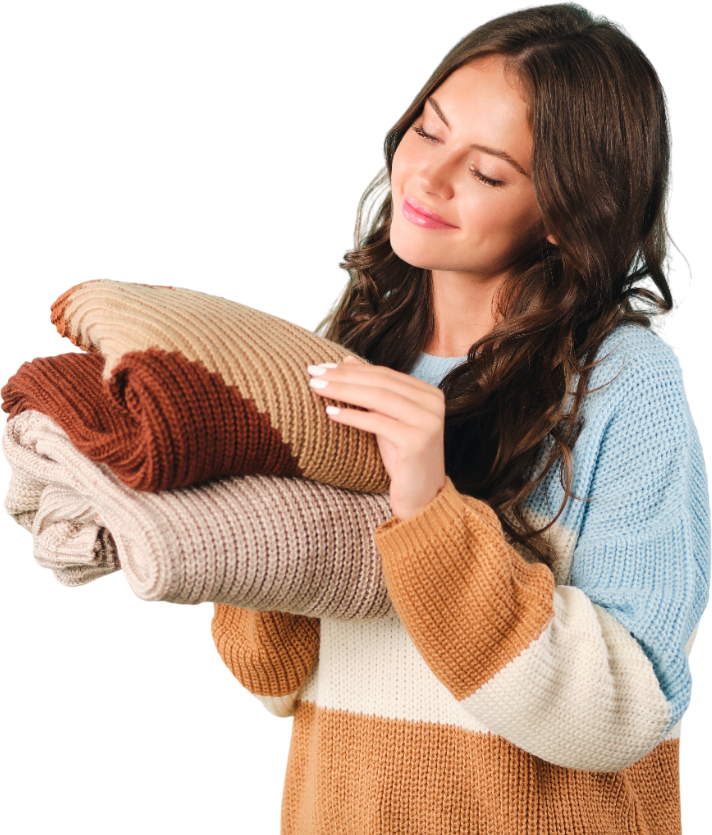 beautiful cute girl dreamily holding cozy knitted sweaters hands blue background Photoroom 1